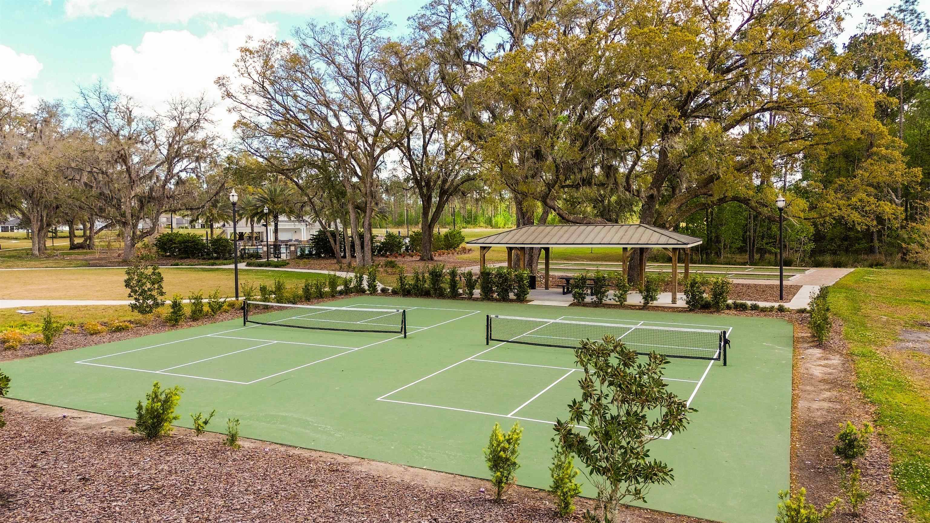 314 Red Barn Road St. Augustine, FL 32092 - Photo 40 of 45 a view of a tennis ground with large trees