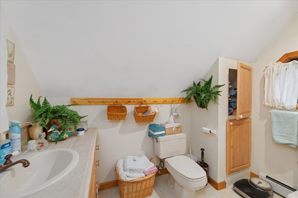 68 Jowders Cove Road Rindge, NH 03461 - Photo 15 of 22 a white toilet sitting next to a bathroom sink and a tub