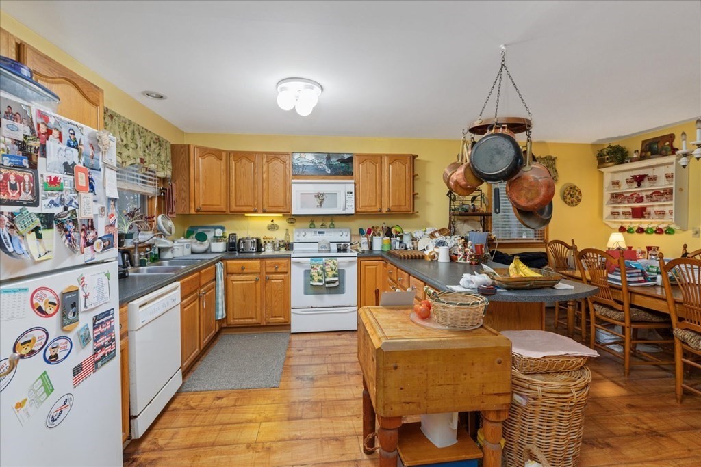 68 Jowders Cove Road Rindge, NH 03461 - Photo 10 of 22 a kitchen with lots of counter top space and wooden floor