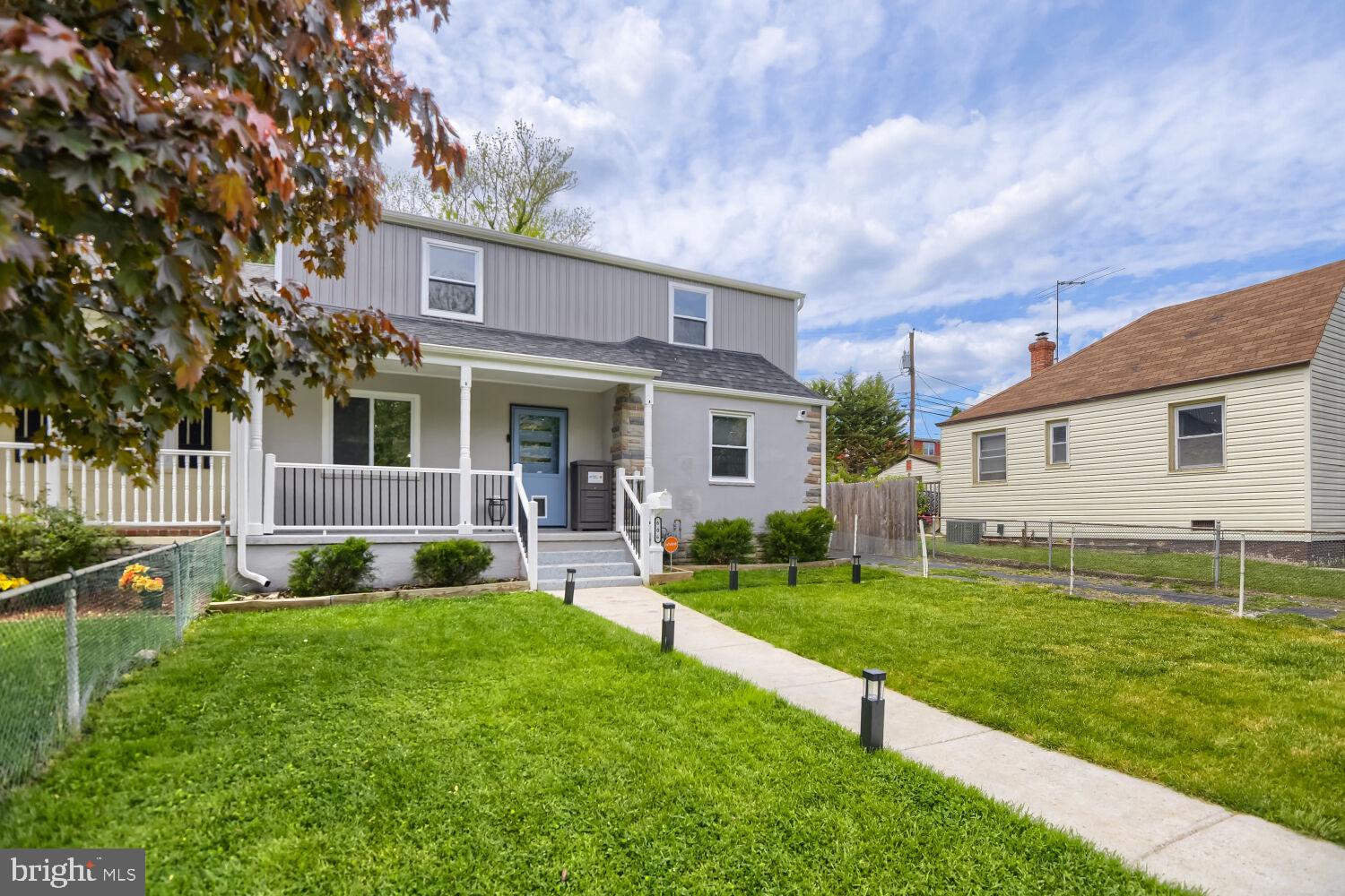 606 Meadow Road Baltimore, MD 21206 - Photo 3 of 27 a front view of a house with a yard and trees