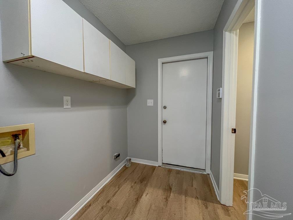 4285 Dana Street Pace, FL 32571 - Photo 16 of 26 a view of an empty room with wooden floor and closet