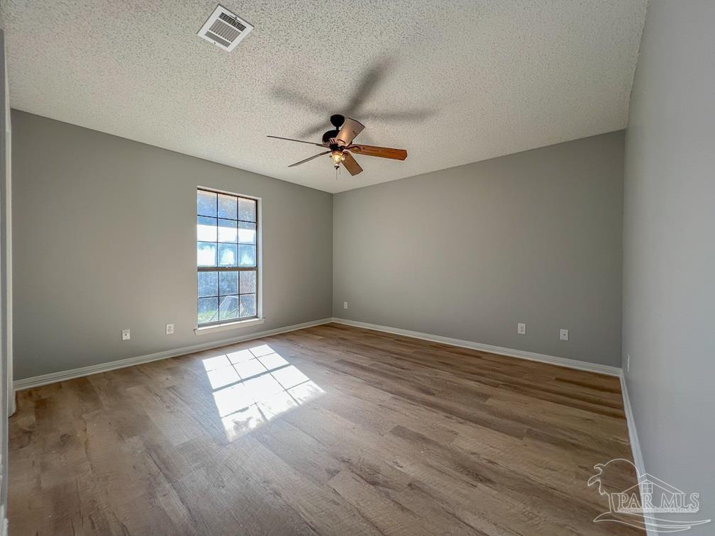 4285 Dana Street Pace, FL 32571 - Photo 21 of 26 wooden floor in an empty room with a window