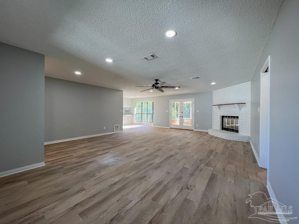 4285 Dana Street Pace, FL 32571 - Photo 3 of 26 a view of empty room with wooden floor and a window