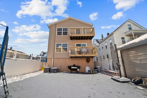 a view of a house with a flat space and a car park side of it