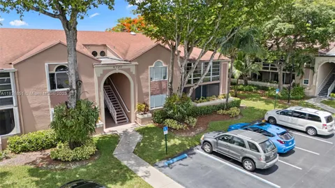 an aerial view of a residential houses with outdoor space