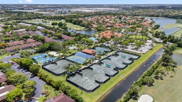 an aerial view of a house with swimming pool and patio