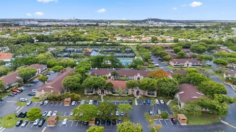 an aerial view of a house with a garden and lake view