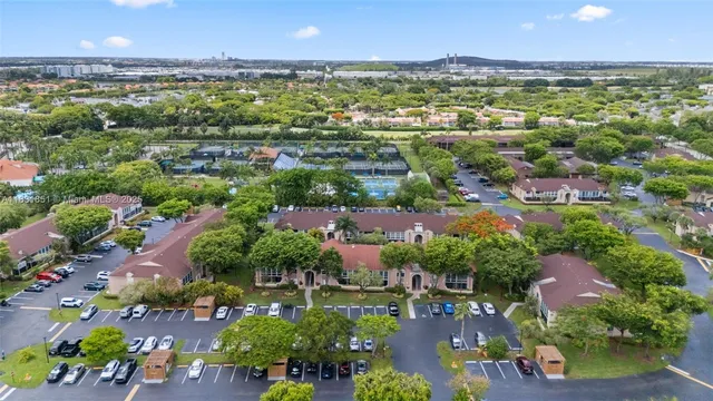 an aerial view of a house with a garden and lake view