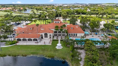 an aerial view of a house with a garden and lake view