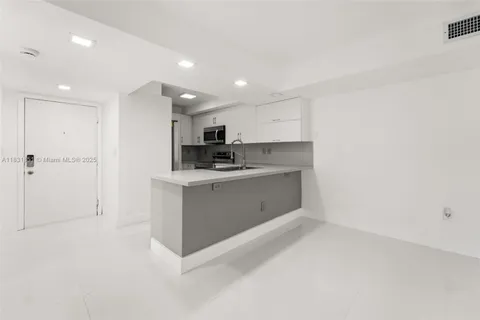 a view of kitchen with cabinets and wooden floor