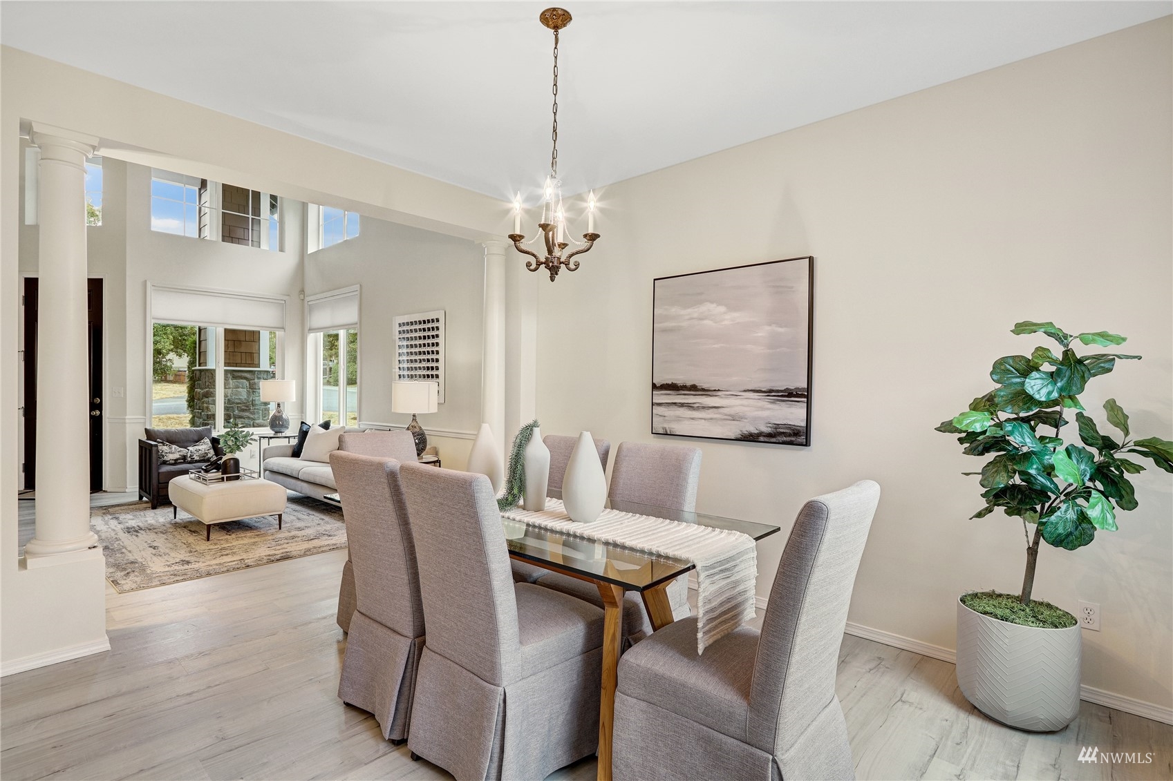 8539 Northeast 202nd Way Bothell, WA 98011 - Photo 4 of 31 a dining room with furniture potted plants and wooden floor