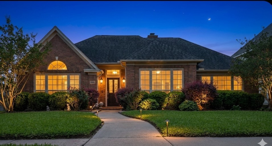 13107 Walnut Lake Road Houston, TX 77065 - Photo 1 of 21 a front view of a house with a garden and yard