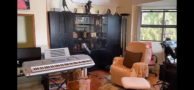 a living room with furniture and a piano