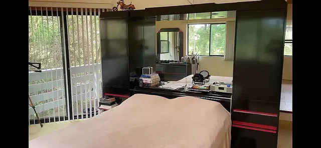 a bedroom with a bed and a large window