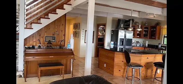 a kitchen view of a kitchen island wooden cabinets and stainless steel appliances