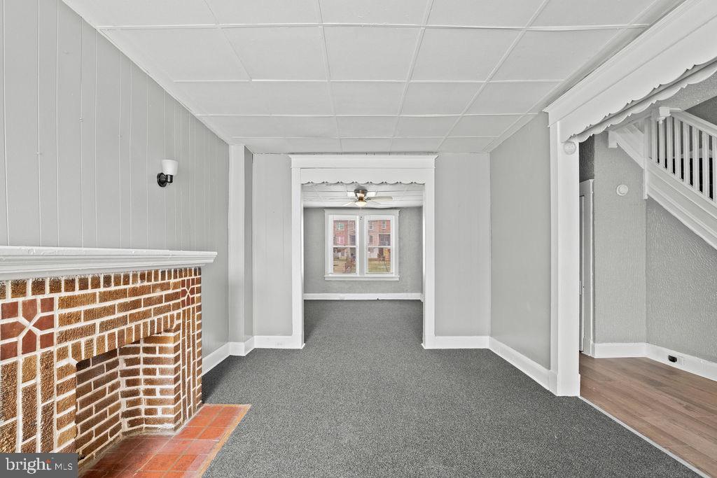 2424 West Lafayette Avenue Baltimore, MD 21216 - Photo 6 of 19 a view of an empty room with a fireplace and a window
