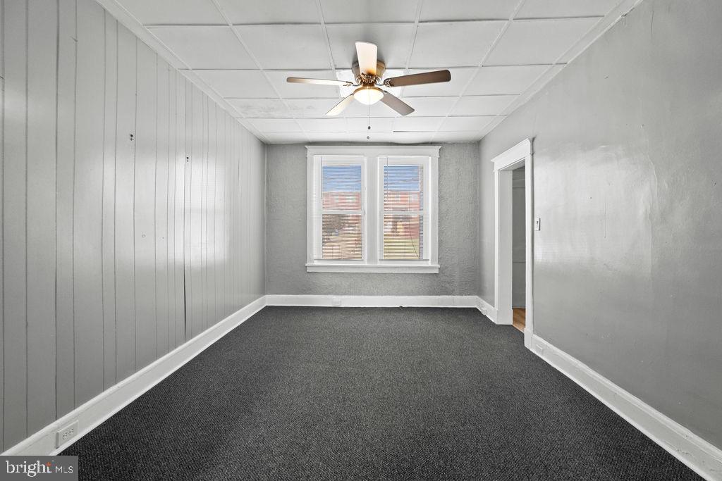 2424 West Lafayette Avenue Baltimore, MD 21216 - Photo 7 of 19 an empty room with windows and fan
