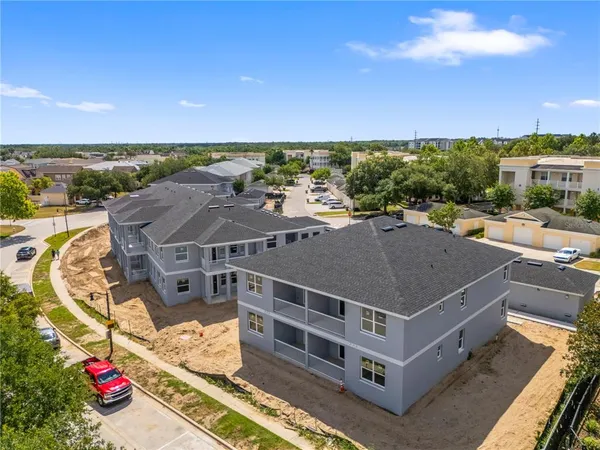 an aerial view of a house with a yard