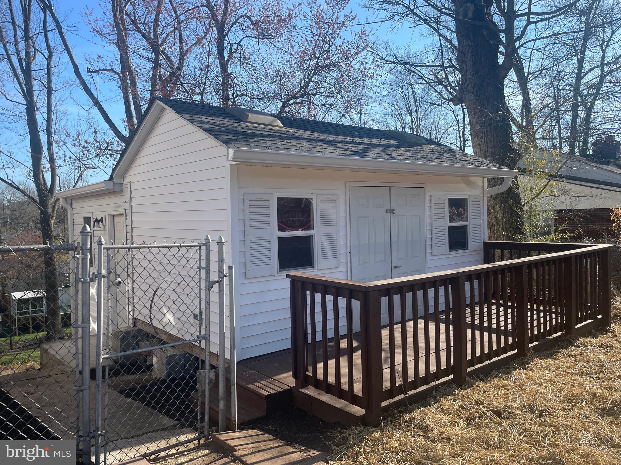 6107 Buckler Road Clinton, MD 20735 - Photo 30 of 45 a view of a house with a small yard and wooden fence