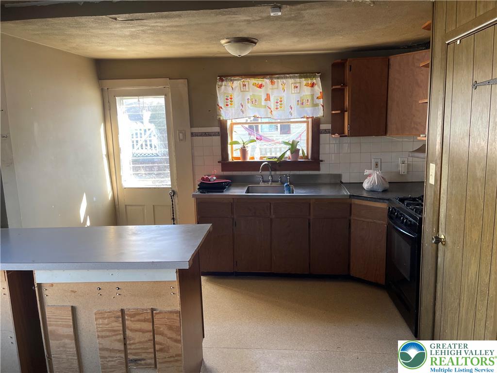 512 Forrest Avenue Bethlehem, PA 18017 - Photo 3 of 22 a kitchen with granite countertop a stove a sink and a microwave
