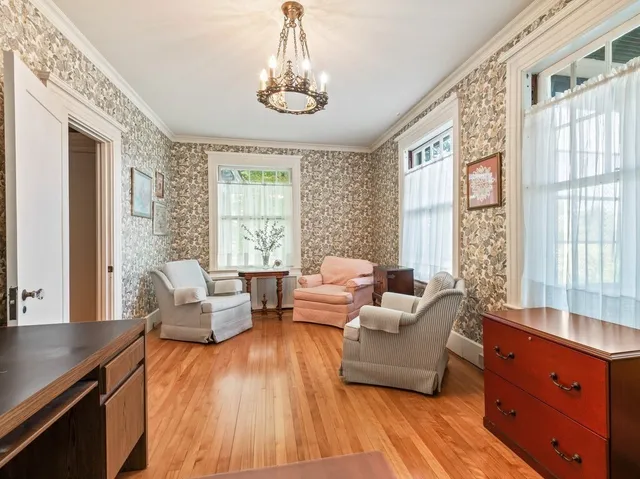 a living room with furniture and large windows
