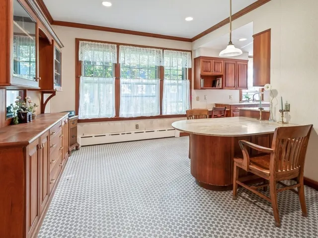 a room with a table chairs and a sink
