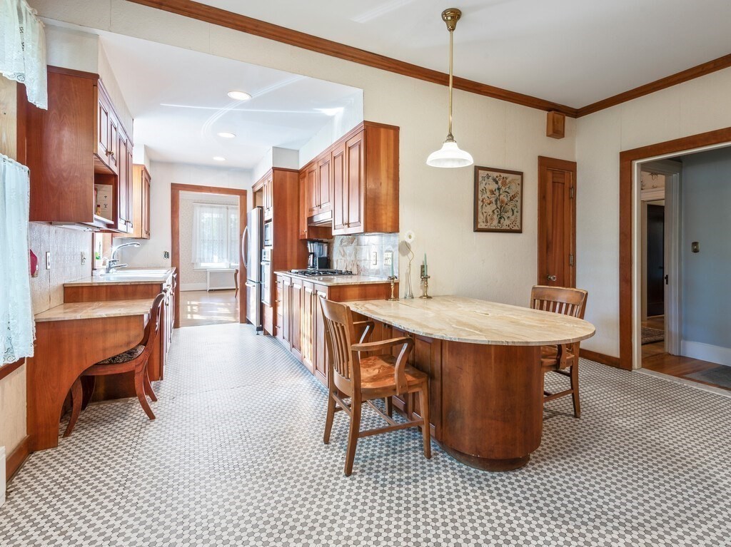 19 Kenilworth Road Worcester, MA 01602 - Photo 15 of 42 a dining hall with stainless steel appliances kitchen island granite countertop a dining table chairs and a refrigerator