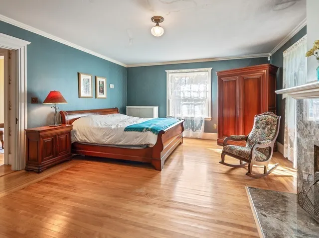 a room with fireplace furniture and a ceiling fan
