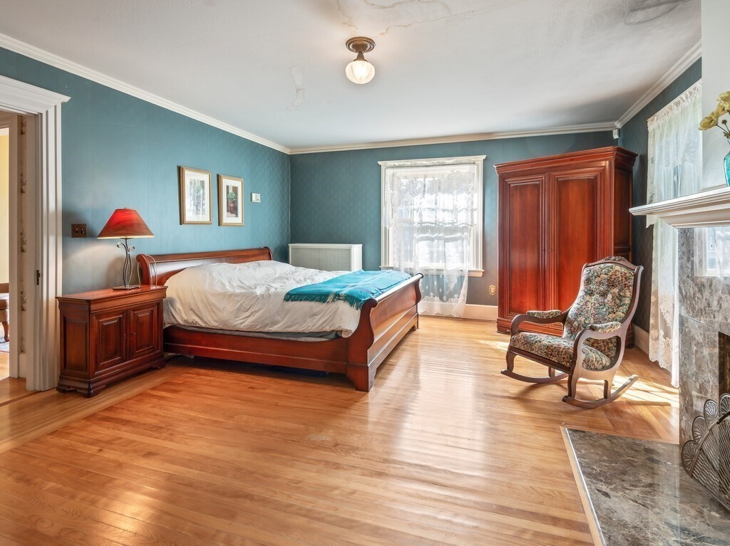 19 Kenilworth Road Worcester, MA 01602 - Photo 26 of 42 a bedroom with a bed and wooden floor