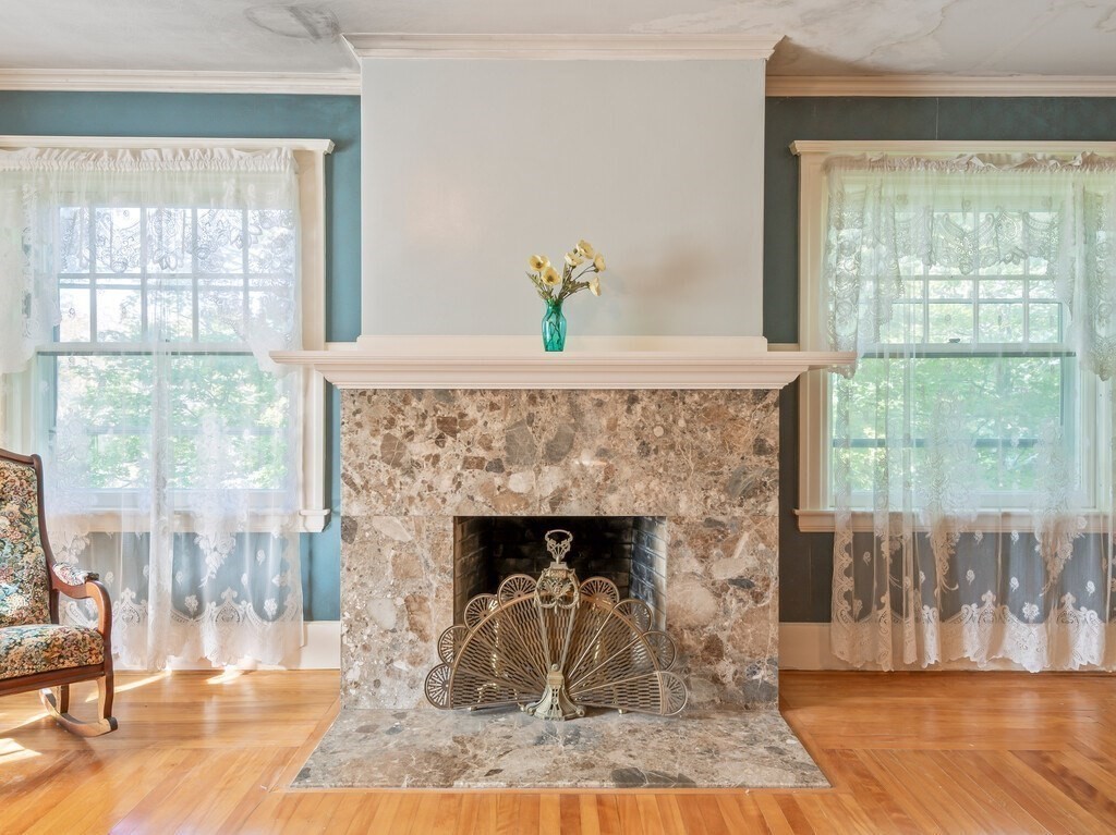 19 Kenilworth Road Worcester, MA 01602 - Photo 28 of 42 a living room with a fireplace and a floor to ceiling window