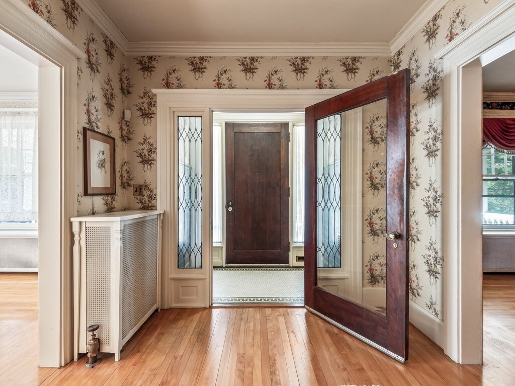 19 Kenilworth Road Worcester, MA 01602 - Photo 3 of 42 a view of a hallway with wooden floor and windows