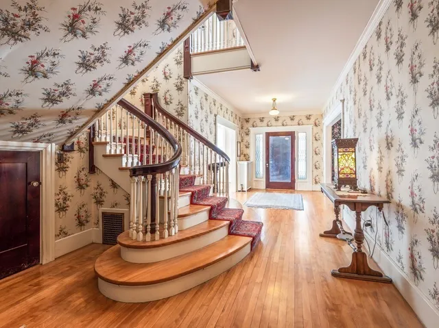 a view of entryway and hall with wooden floor