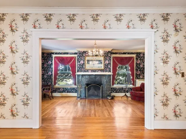 a living room with a fireplace with wooden floor