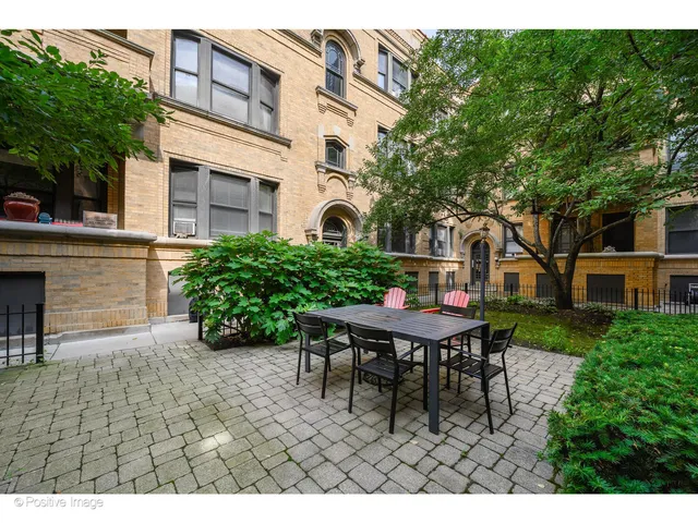 a backyard of a house with table and chairs