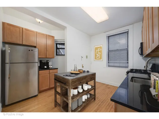 a kitchen with stainless steel appliances granite countertop a refrigerator a stove a sink dishwasher and a refrigerator