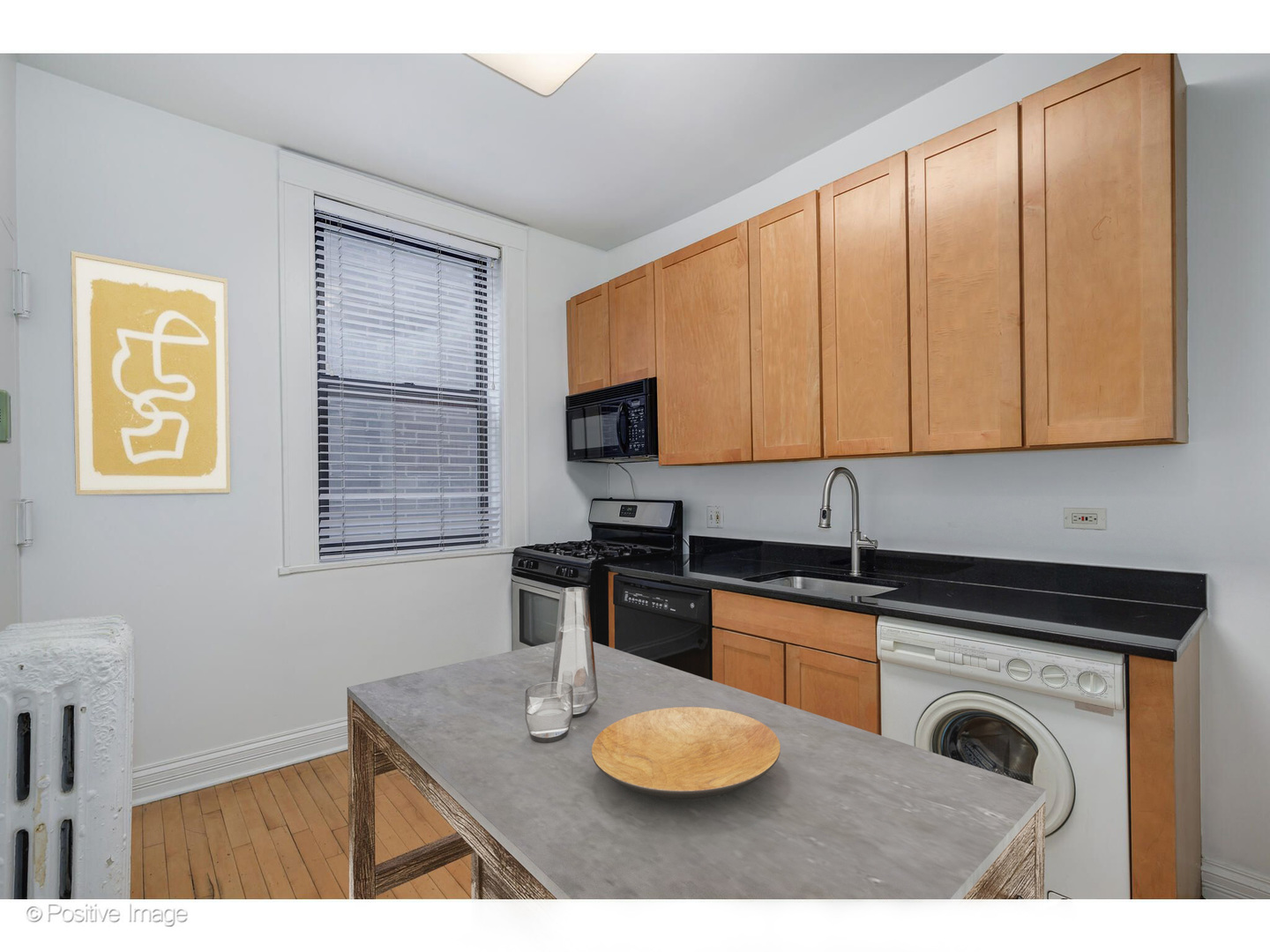 726 West Sheridan Road, Unit 1N Chicago, IL 60613 - Photo 7 of 14 a kitchen with stainless steel appliances granite countertop a sink a stove cabinets and wooden floor