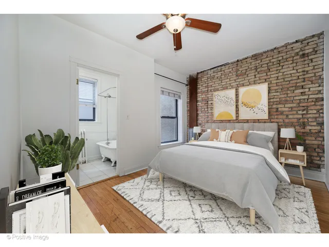 a living room with a bed and a dresser