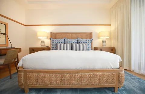 a bed sitting in a bedroom next to a window