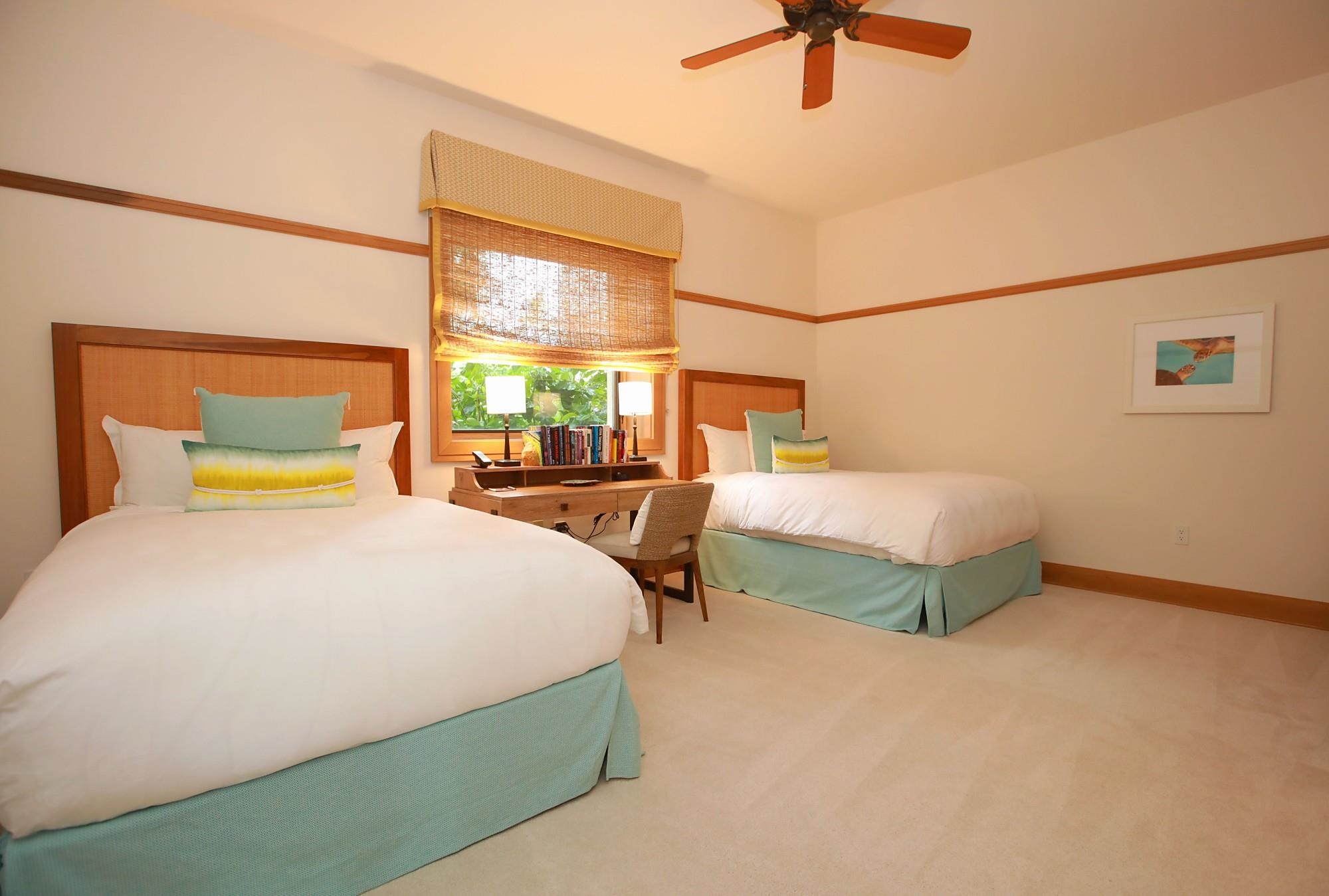 1 Bay Drive, Unit 2202 Lahaina, HI 96761 - Photo 29 of 50 a bedroom with a bed and a chandelier