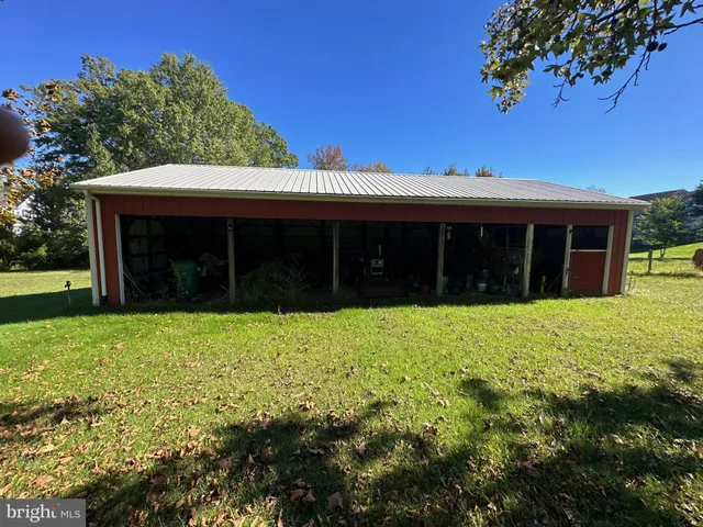 a view of a house with a yard and potted plants