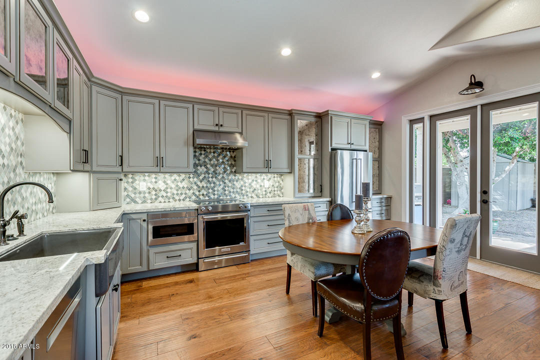 3351 West Drake Street Chandler, AZ 85226 - Photo 9 of 20 a kitchen with kitchen island a stove a table and chairs in it