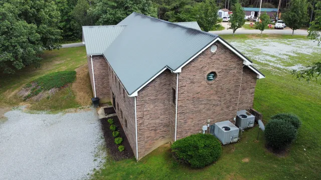 an aerial view of a house with swimming pool and garden