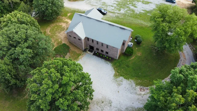 an aerial view of a house with roof deck and tree