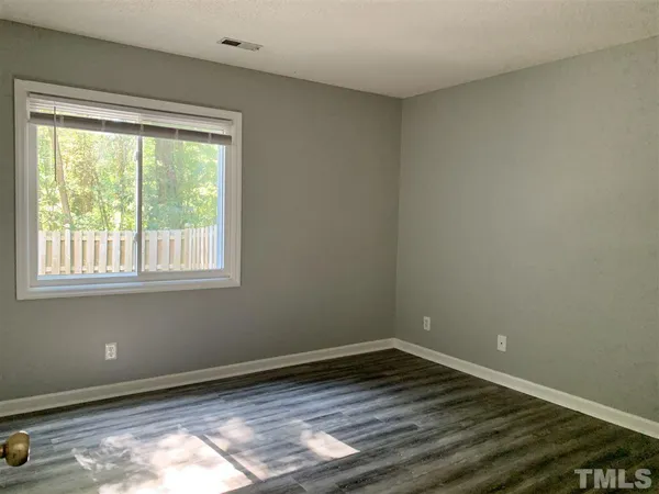 a big room with wooden floor and windows