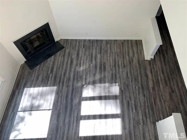 a living room with a bed furniture and a large window