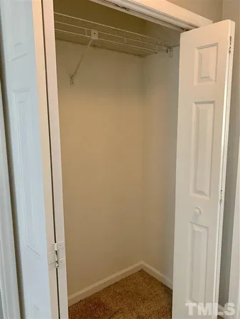 a small space with wooden floor and a window