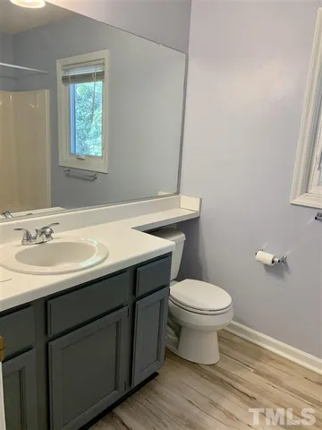 a bathroom with a sink toilet and a window
