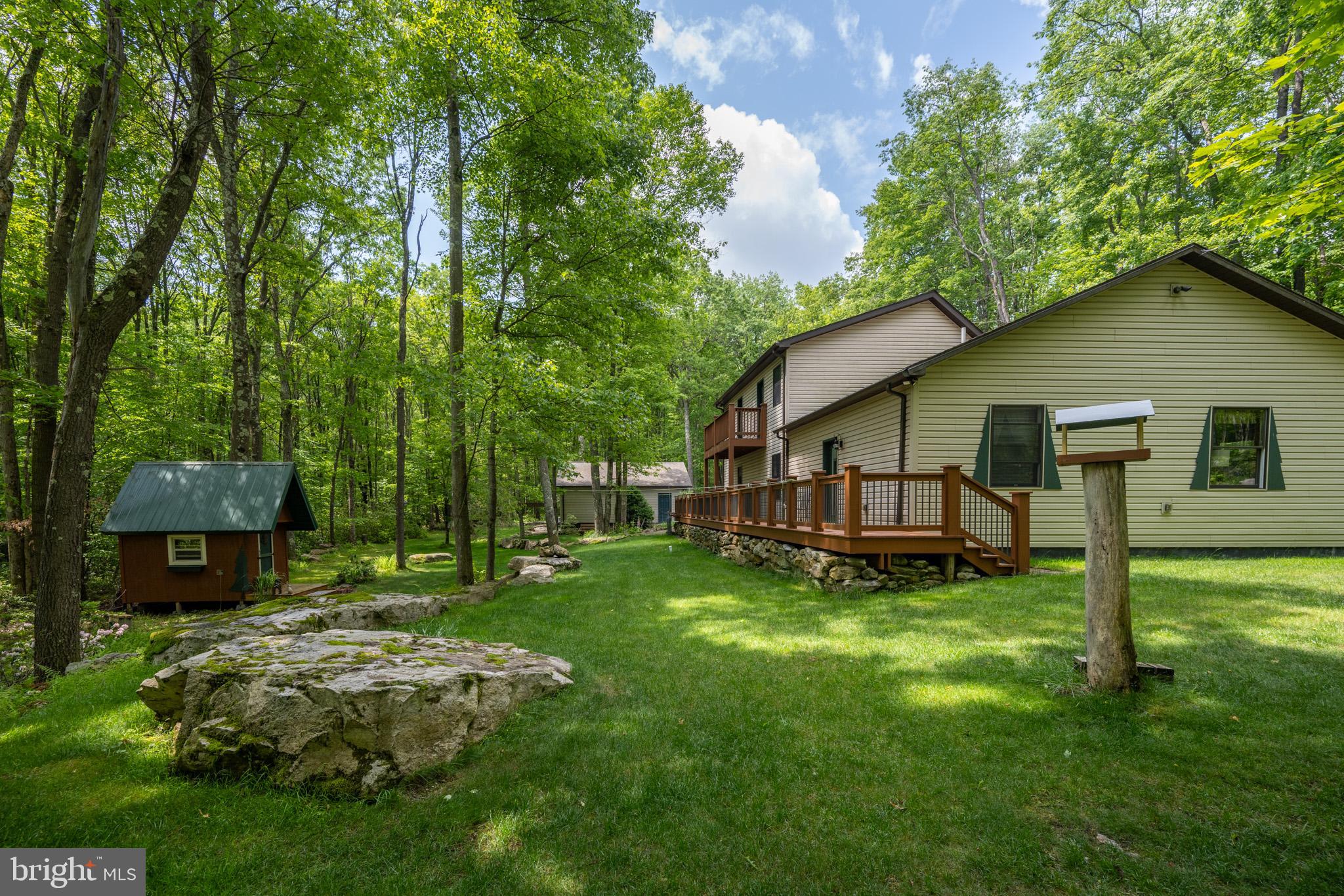 328 Stool Rock Road Oakland, MD 21550 - Photo 111 of 123 a backyard of a house with lawn chairs and a yard