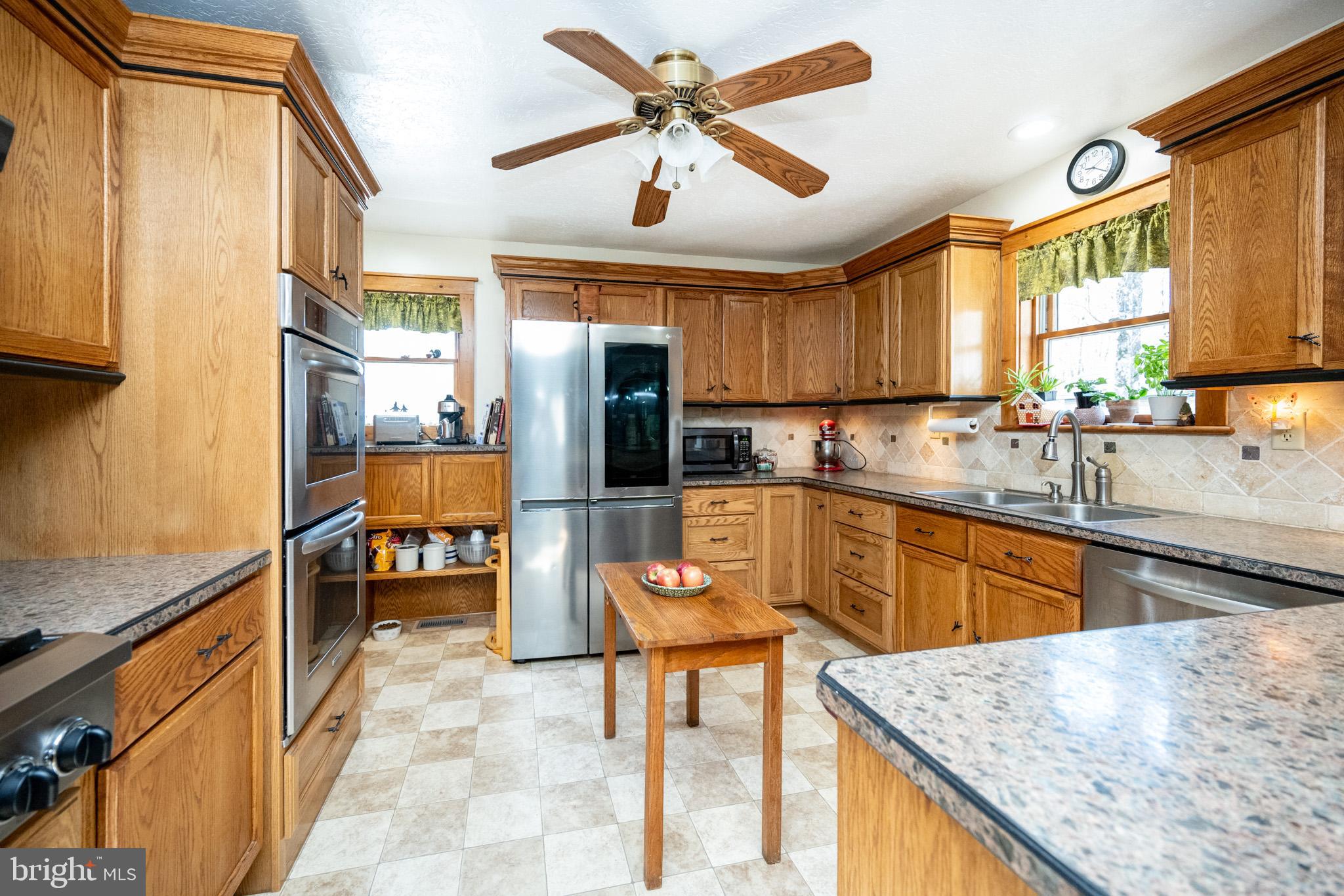 328 Stool Rock Road Oakland, MD 21550 - Photo 29 of 123 a kitchen with stainless steel appliances granite countertop a sink a stove and a refrigerator