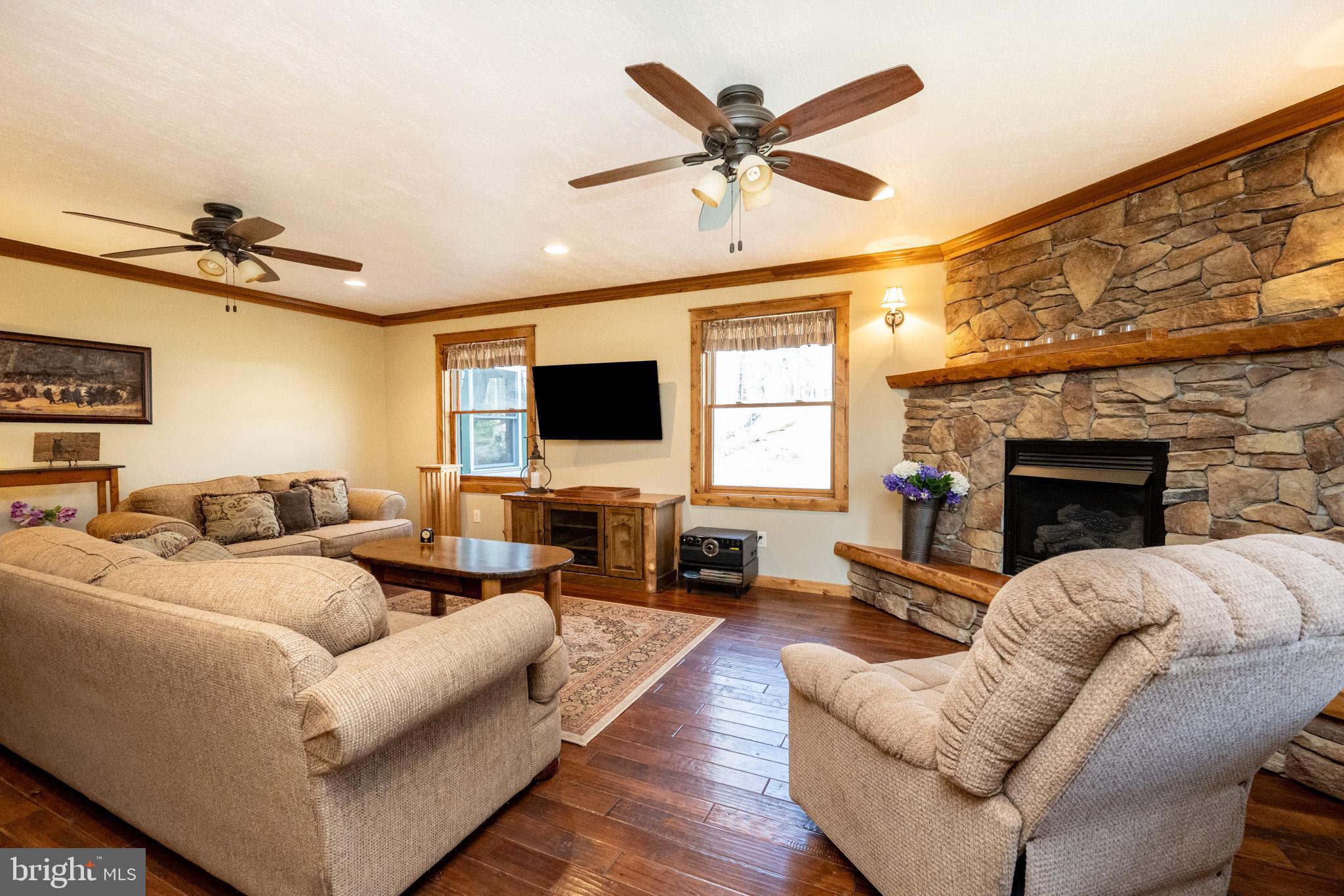 328 Stool Rock Road Oakland, MD 21550 - Photo 45 of 117 a living room with furniture a fireplace and a flat screen tv